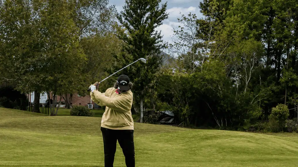 Brenda Goburn Smith preparing for a golf swing as a metaphor for career review and coaching